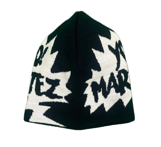 A black knit beanie hat featuring a white graphic pattern of jagged lightning bolts and the text 'YO! MARTEZ' in a stylized font.