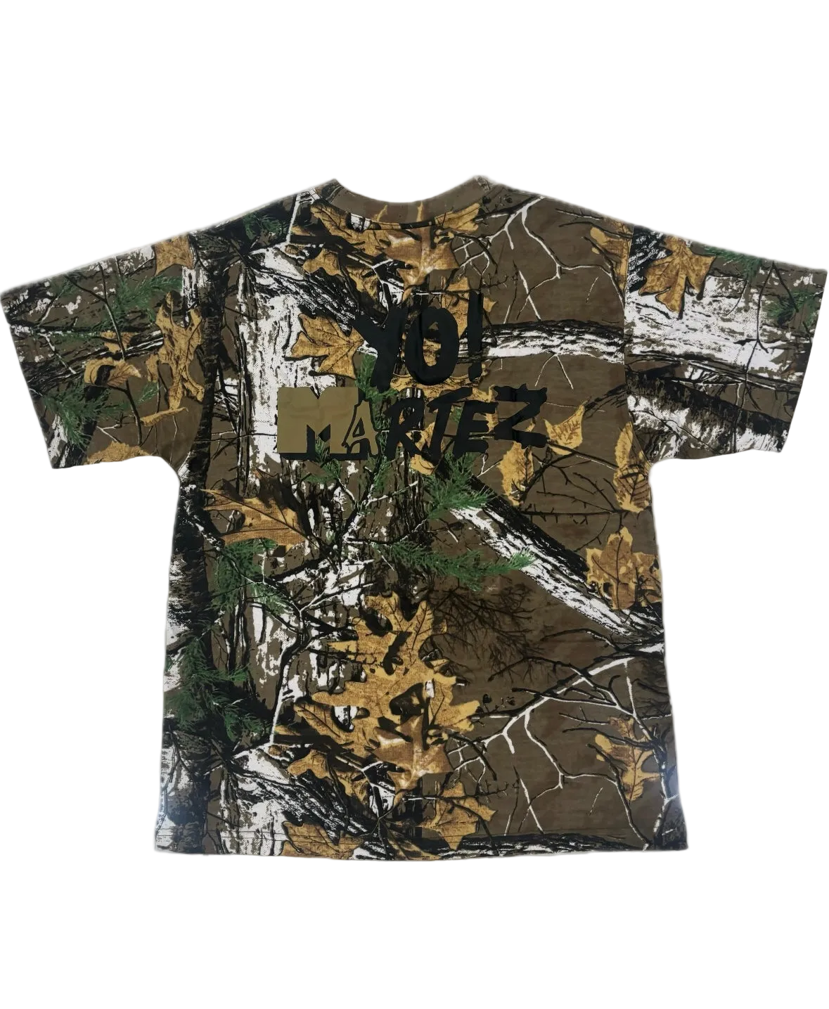 A short-sleeve crewneck t-shirt featuring a brown and green woodland camouflage pattern with a black 'JOL MARTEZ' graphic printed across the chest.