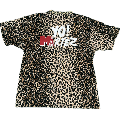 A short-sleeve crewneck t-shirt featuring a classic leopard print pattern in beige, brown, and black, with a red and white 'YO! MARTEZ' graphic printed across the chest.