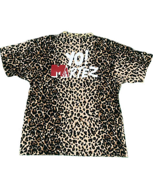 A short-sleeve crewneck t-shirt featuring a classic leopard print pattern in beige, brown, and black, with a red and white 'YO! MARTEZ' graphic printed across the chest.