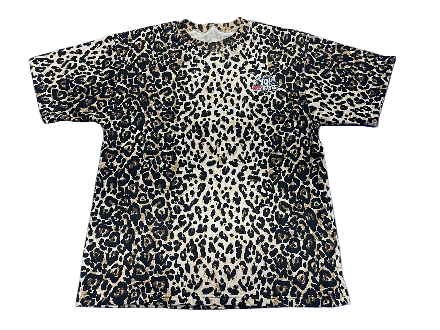 A short-sleeve crewneck t-shirt featuring a leopard print pattern in black, beige, and brown, with a small graphic on the left chest.