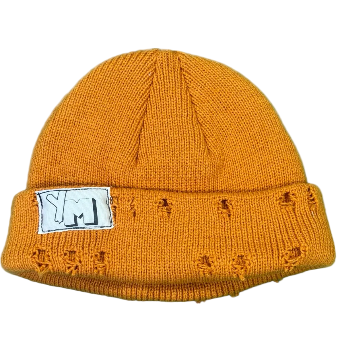 Mustard yellow knit beanie with a white label on a white background
