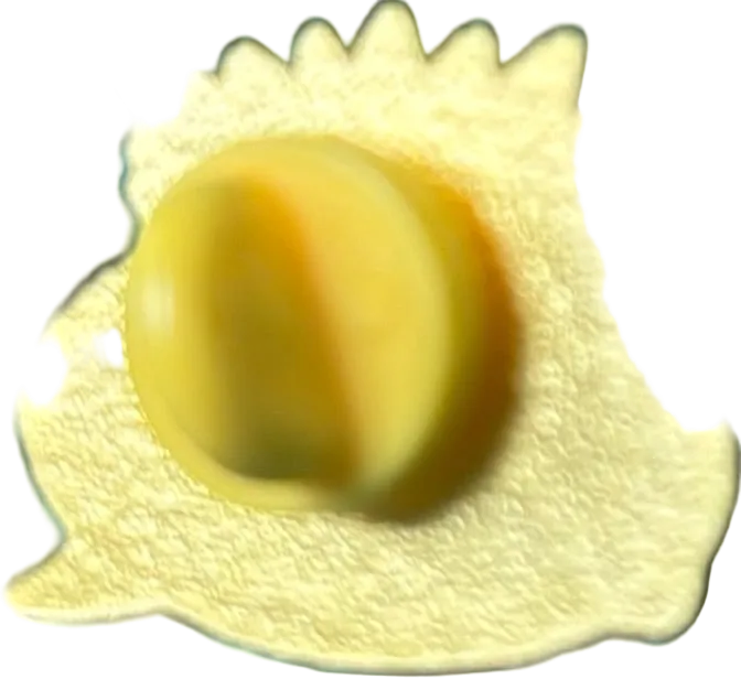 Close-up of a yellow object with a textured surface on a black background