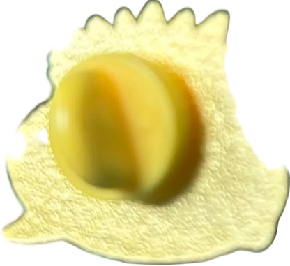 Close-up of a yellow object with a textured surface on a black background