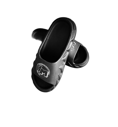A pair of black slides with a white YM logo on the footbed,