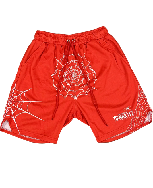 Red athletic shorts with a white spider web pattern and spider graphics on the legs, waistband, and a logo on the left leg.