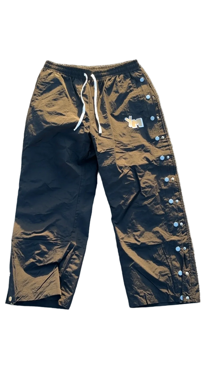 A pair of black track pants with an elastic waistband and drawstring, featuring 'YM' on the leg for "Yo! Martez."