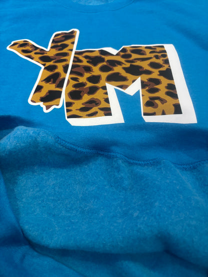 Turquoise sweater with a large white letter 'YM' featuring a leopard print design.