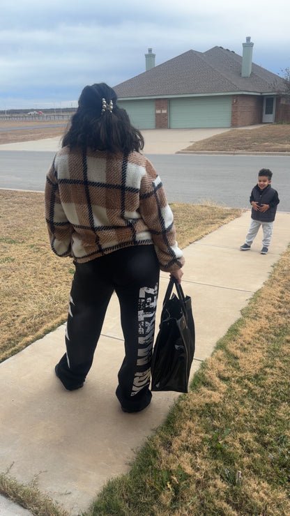 Mrs. Yo! Martez rocking the black YM Faded Glory sweatpants paired with a nice jacket and bag accessory. Son Maze seems to approve.